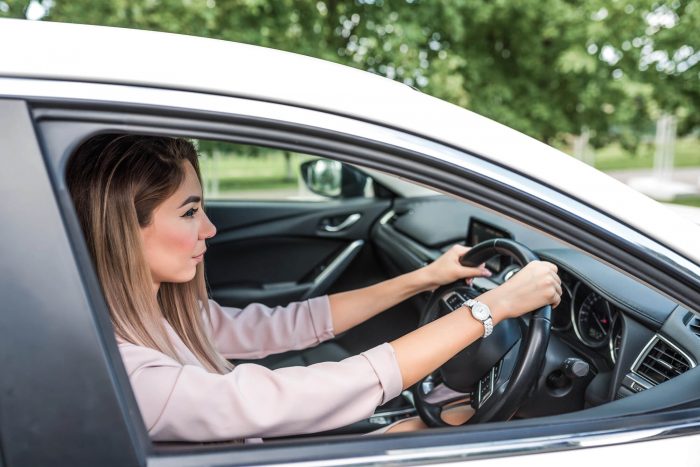 woman lady driving a car right hand drive